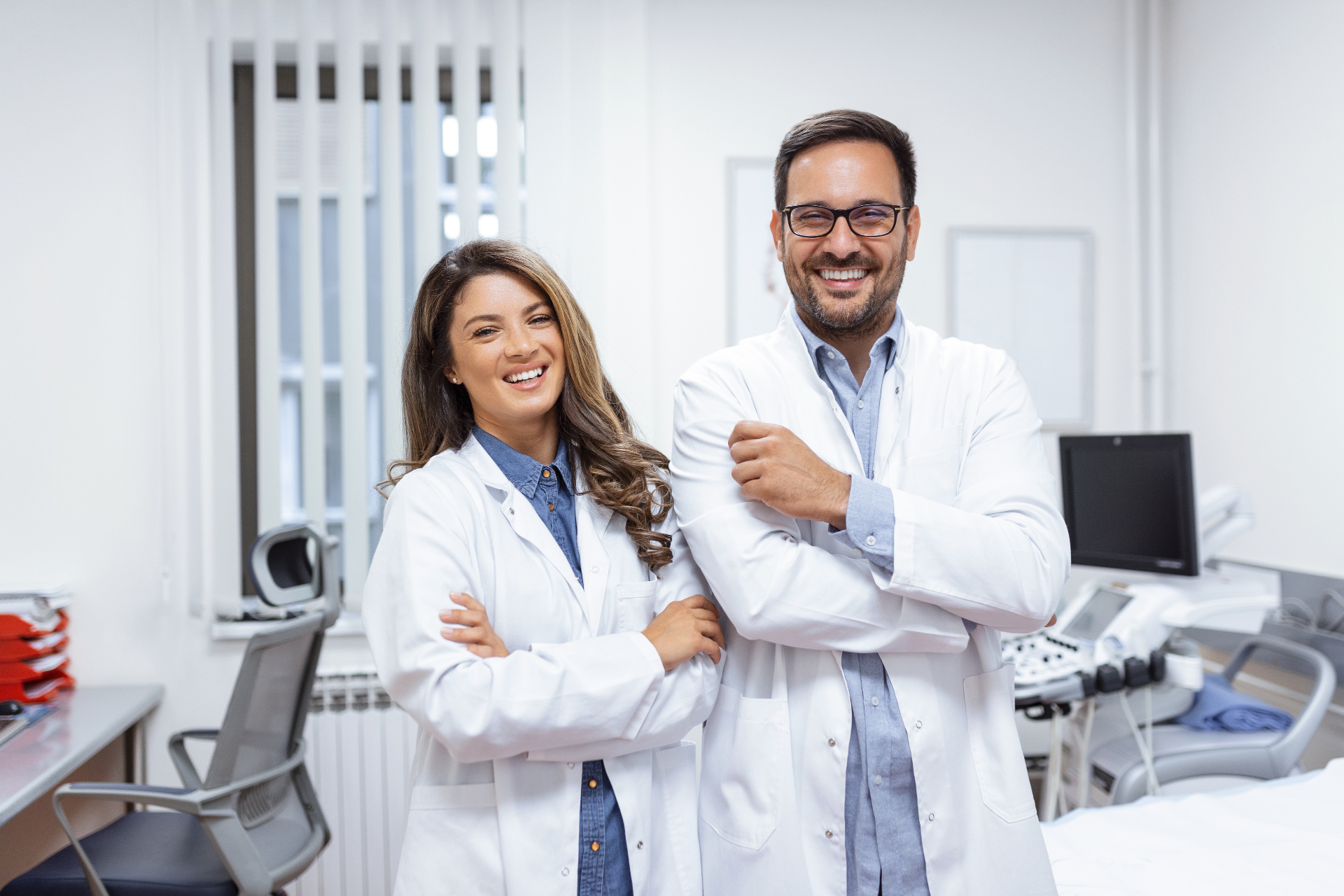 Two smiling dentists in a clinic