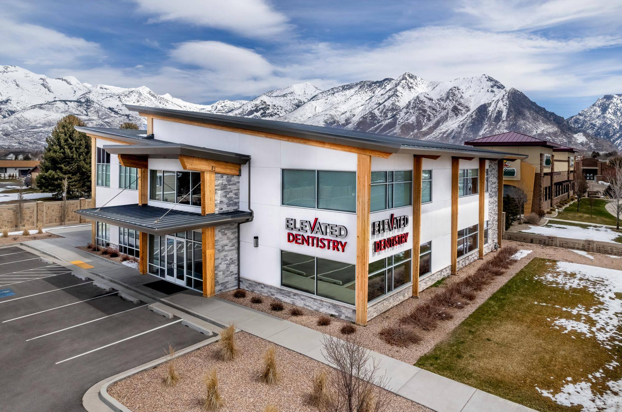 Modern dental office exterior with mountain backdrop